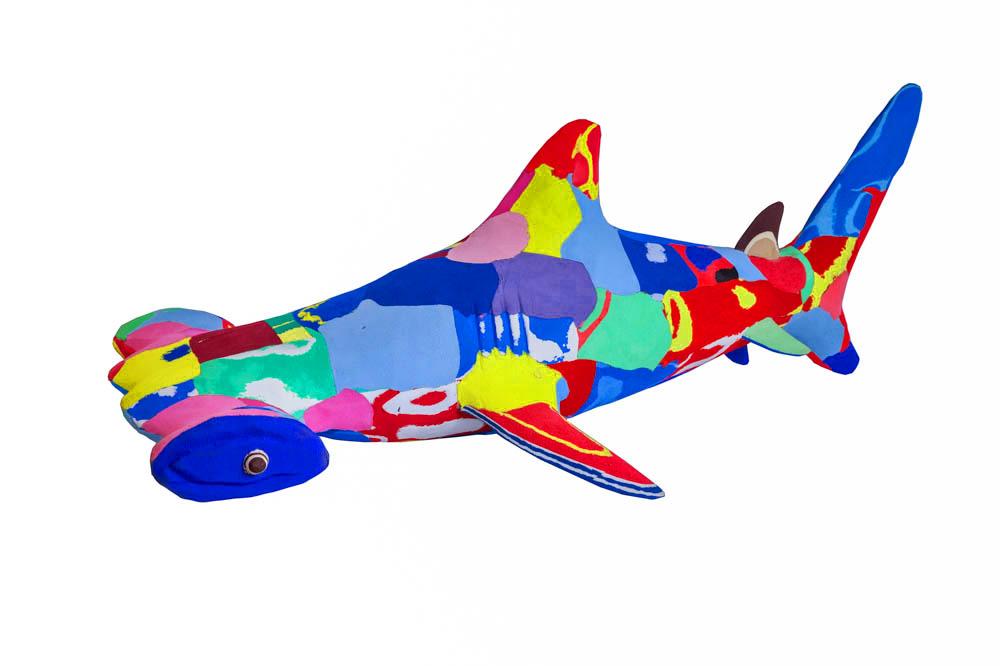 Hand-carved multicolored hammerhead shark sculpture made of upcycled flip flops by Ocean Sole.