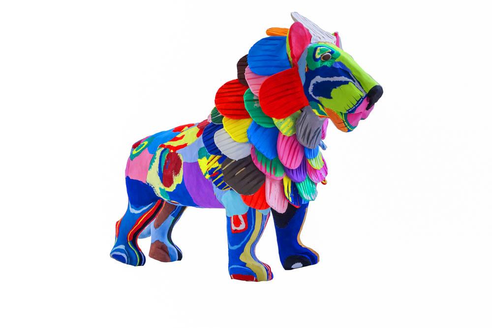 Large hand-carved multicolored standing lion sculpture made of upcycled flip flops by Ocean Sole.