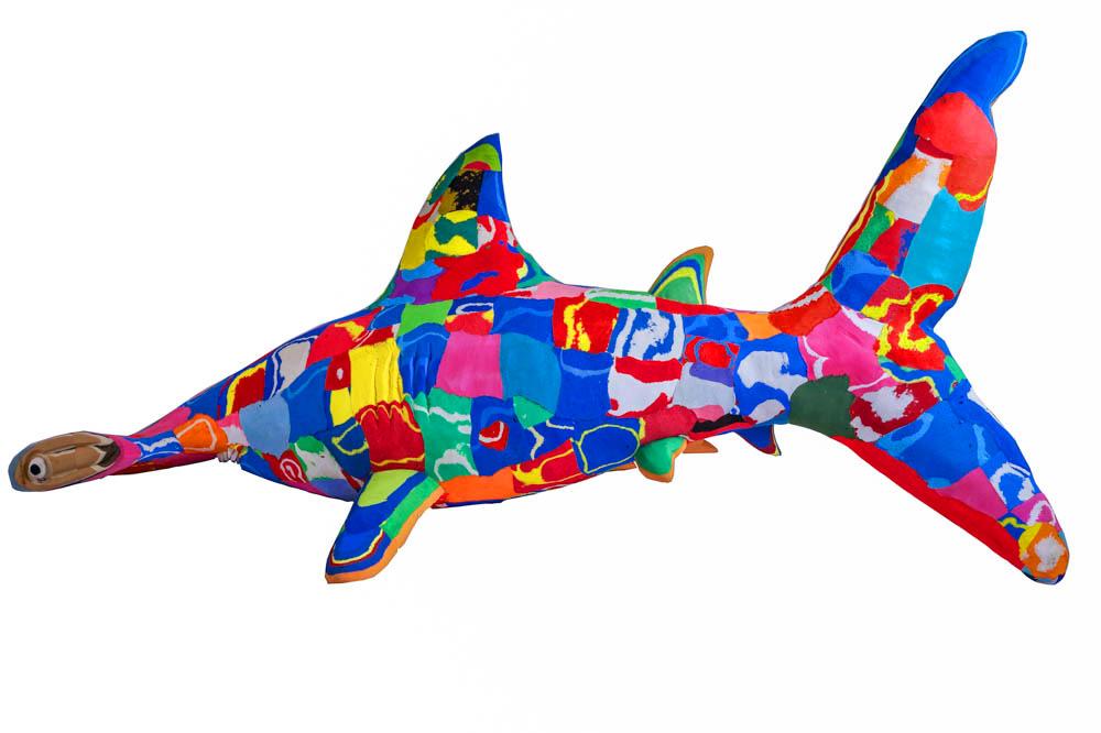 Hand-carved multicolored hammerhead shark sculpture made of upcycled flip flops by Ocean Sole.