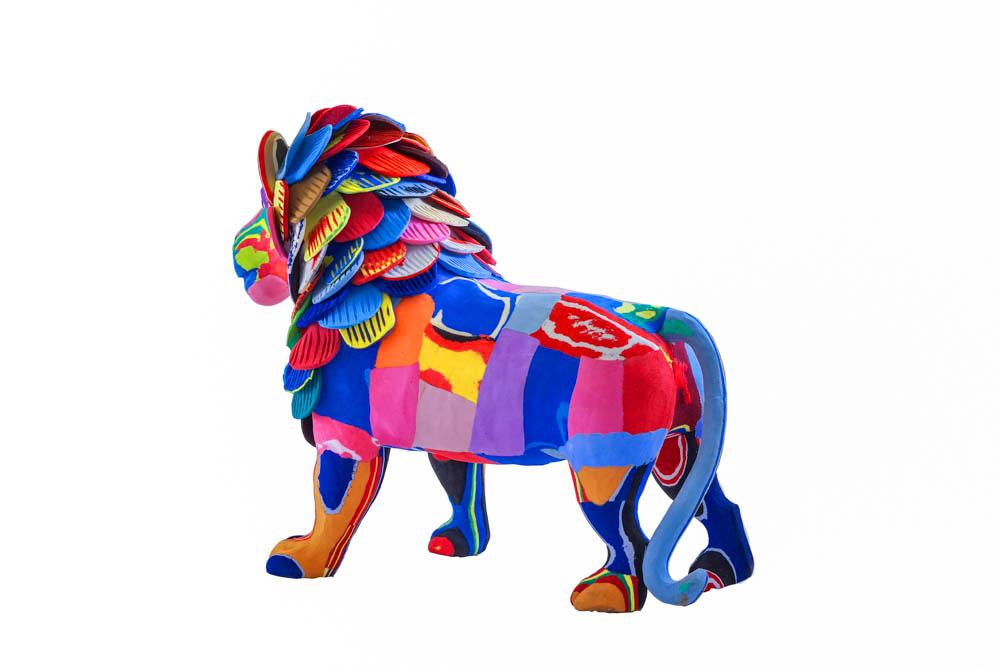 Large hand-carved multicolored standing lion sculpture made of upcycled flip flops by Ocean Sole.