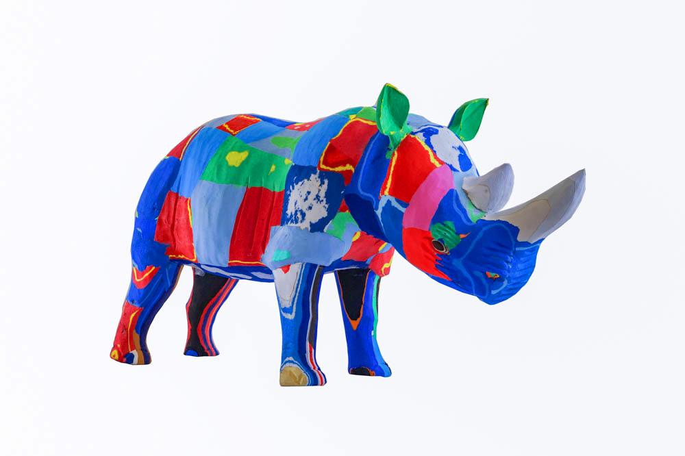 Hand-carved multicolored rhino sculpture made of upcycled flip flops by Ocean Sole.