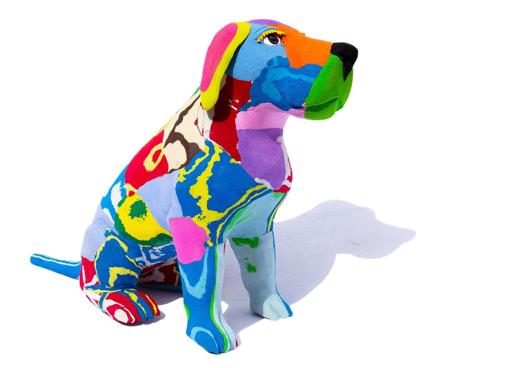 Hand-carved multicolored sitting lab dog sculpture made of upcycled flip flops by Ocean Sole.