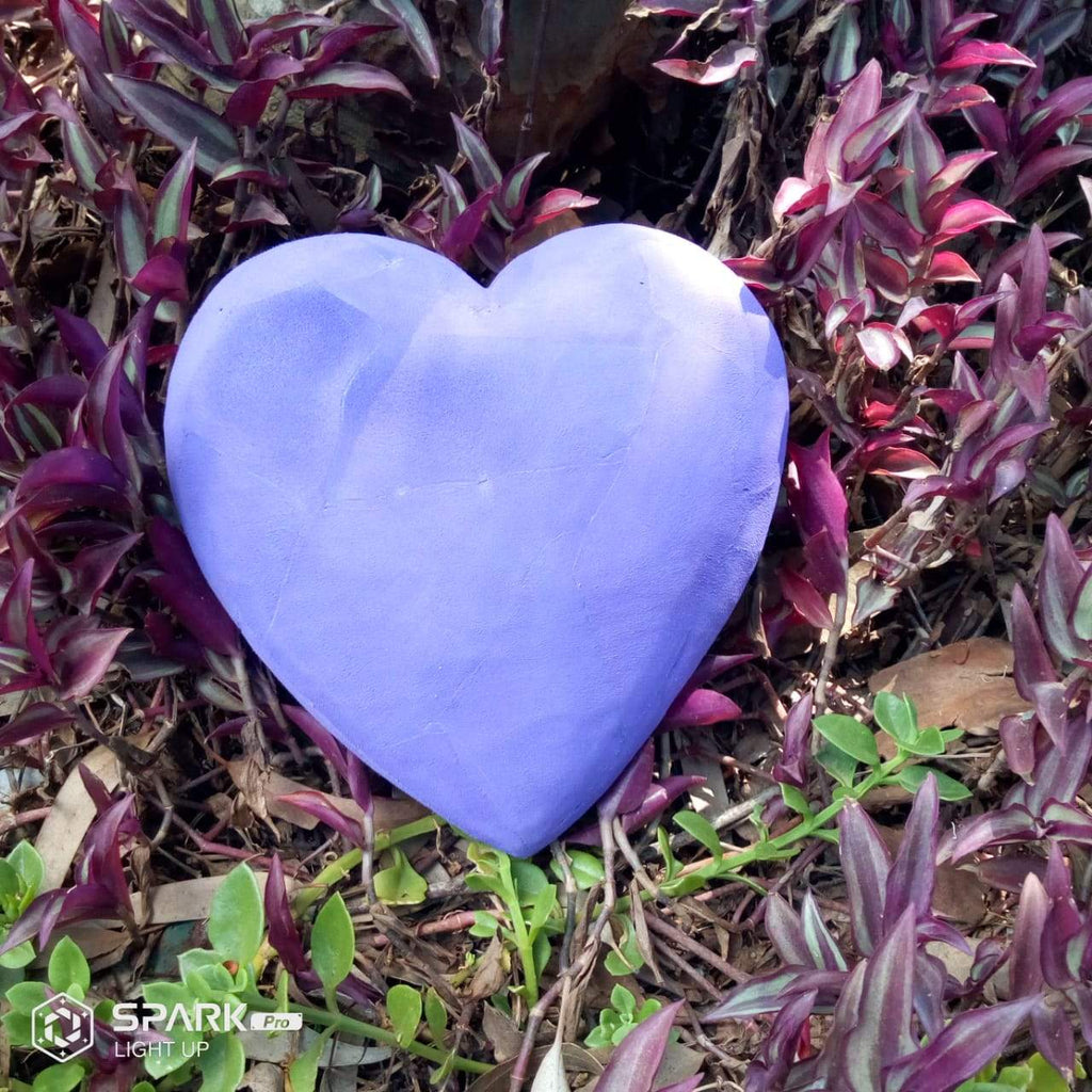 Hand-carved purple heart sculpture made of upcycled flip flops by Ocean Sole.