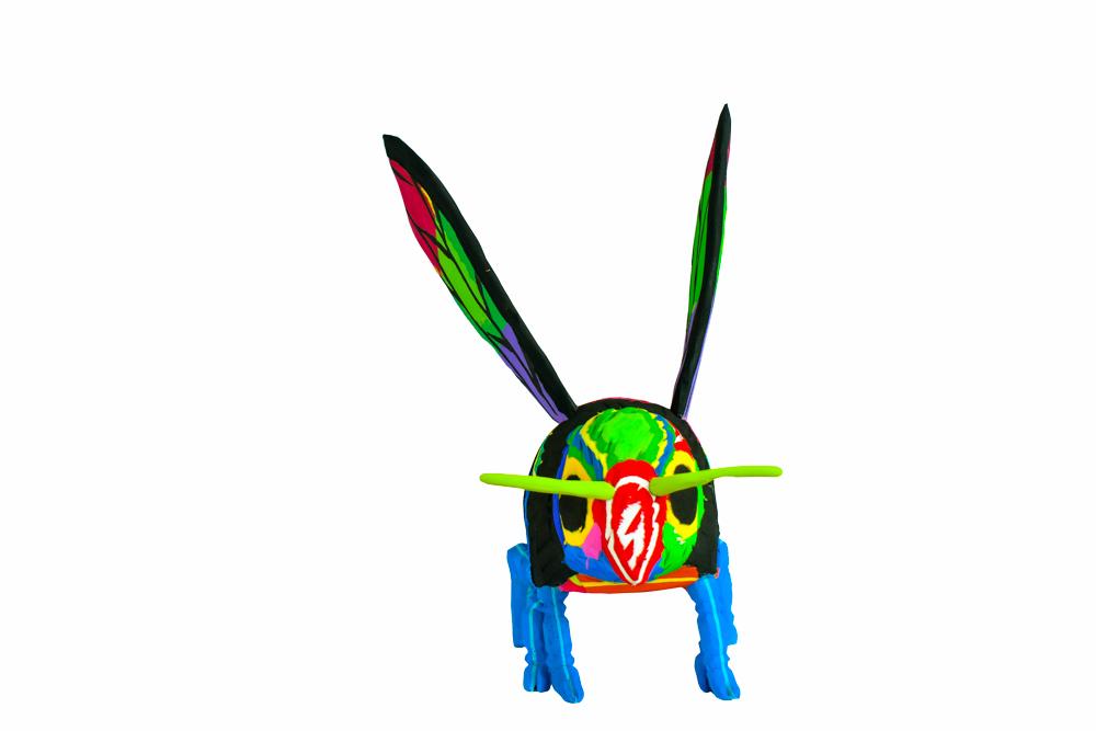 Hand-carved multicolored bee sculpture made of upcycled flip flops by Ocean Sole.
