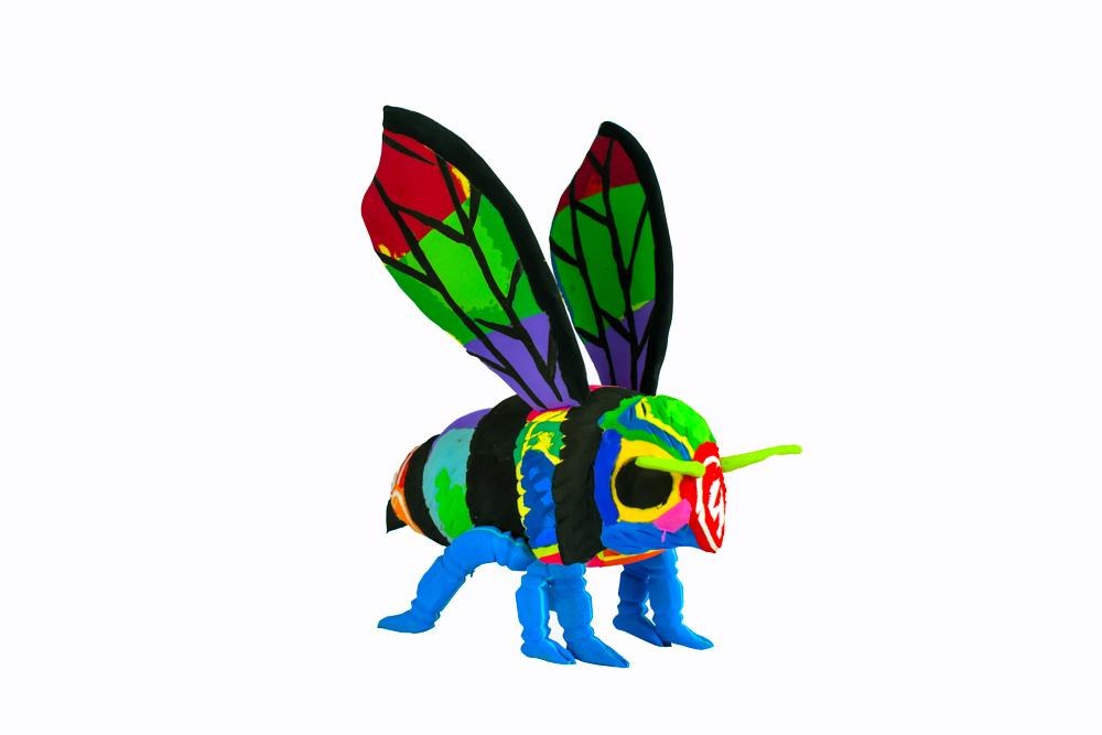Hand-carved multicolored bee sculpture made of upcycled flip flops by Ocean Sole.