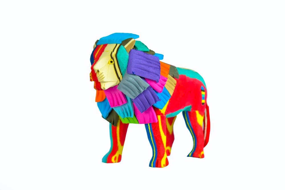 Hand-carved multicolored standing lion sculpture made of upcycled flip flops by Ocean Sole.