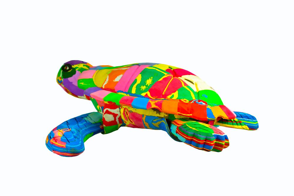Large hand-carved multicolored turtle sculpture made of upcycled flip flops by Ocean Sole.
